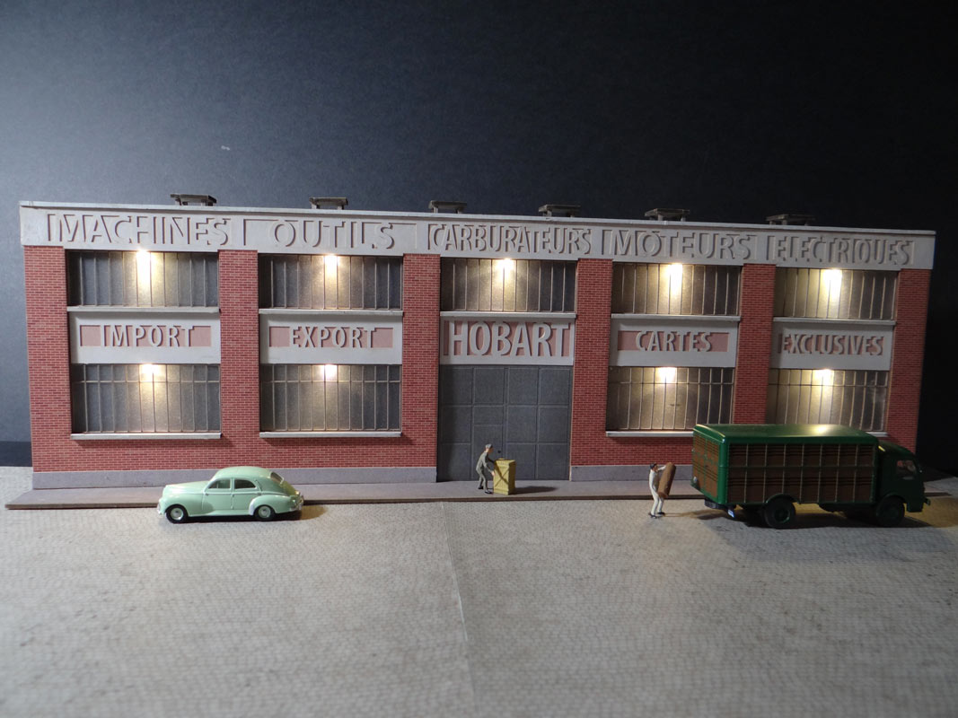 Fond de décor en relief d´une usine avec baies éclairées "Machines outils - Carburateurs"